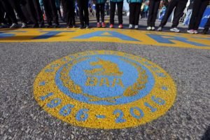 An seal honoring 50 years of women running in the Boston Marathon covers the street in front of the start line of the 120th Boston Marathon on Monday, April 18, 2016, in Hopkinton, Mass. (AP Photo/Michael Dwyer)